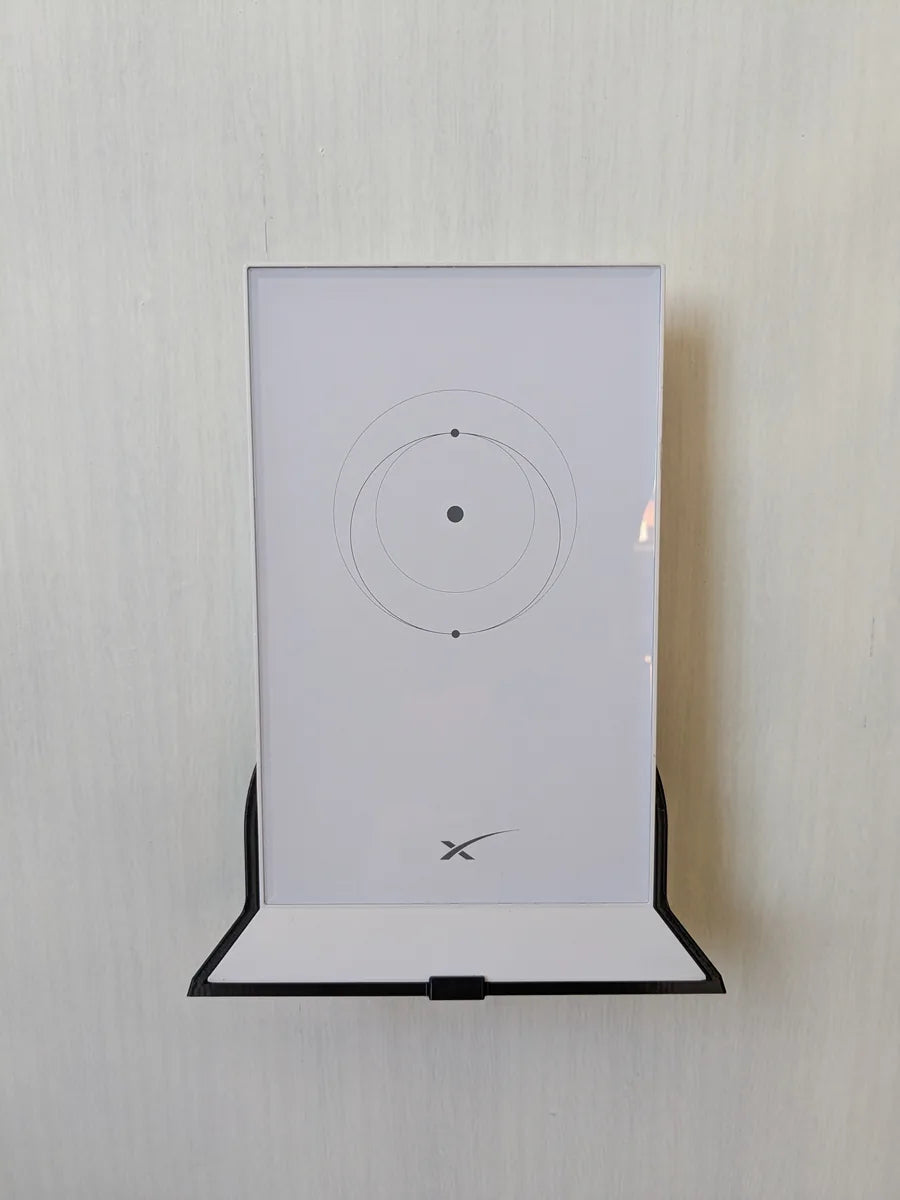 Starlink Gen 2 router held against a wall by the black StarMax 3D-printed mount, front view.