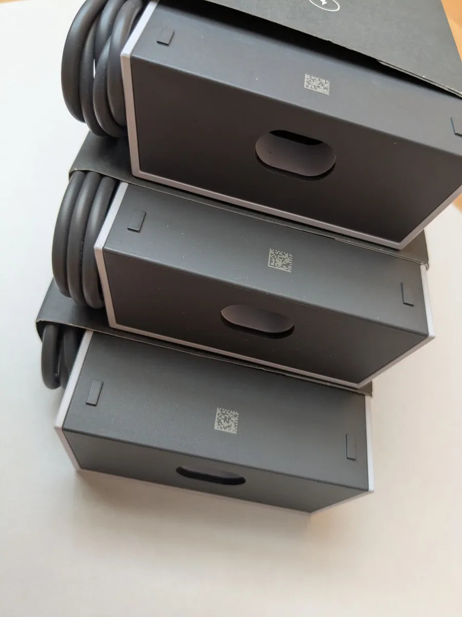 Three boxed Starlink Gen 3 power supplies stacked, each with the coiled cable held at the side.