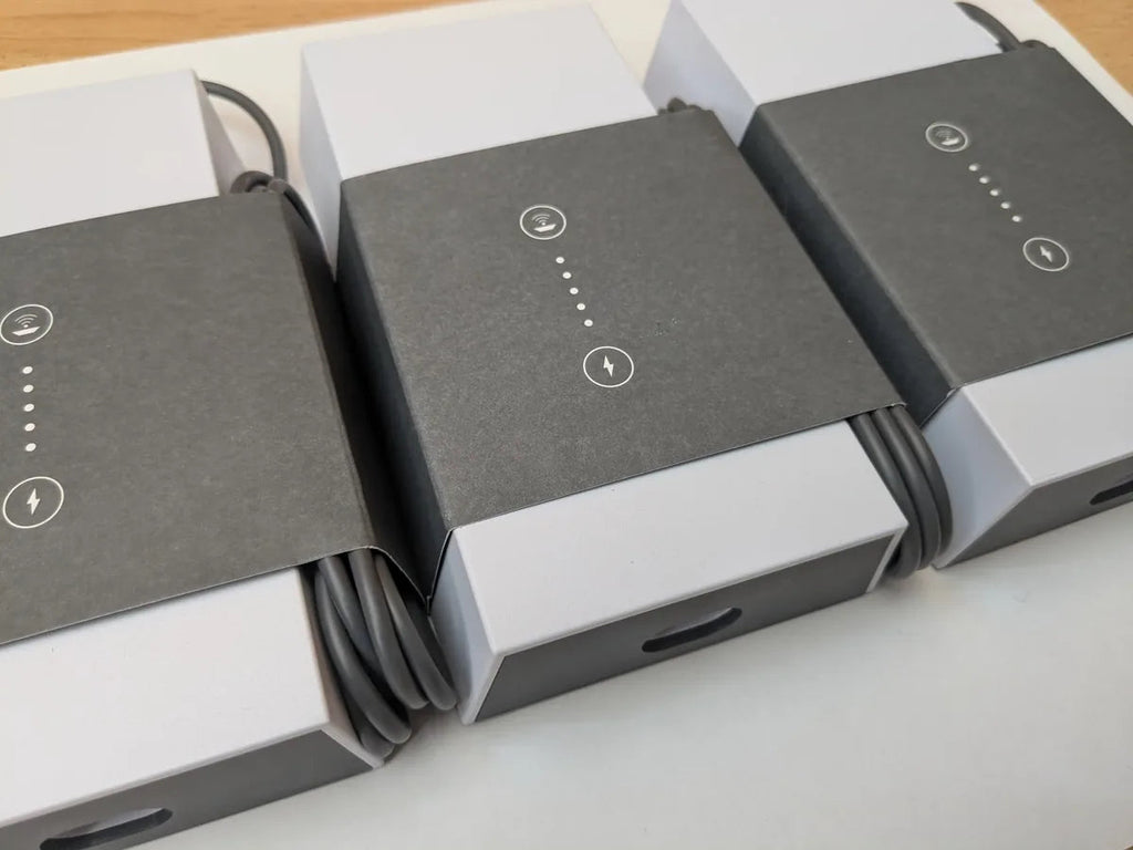 Three Starlink Gen 3 power supplies in original packaging, lined up with cables wound in place.
