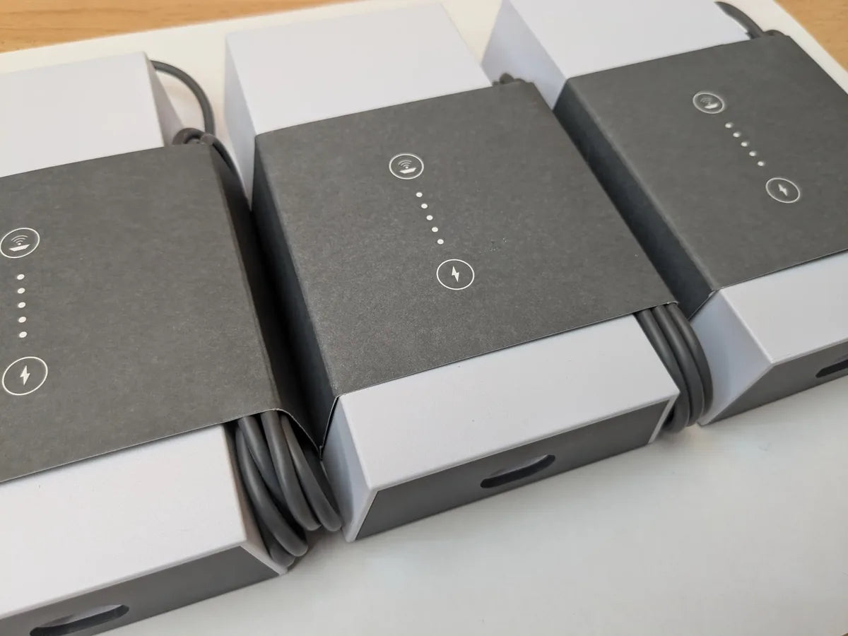 Three Starlink Gen 3 power supplies in original packaging, lined up with cables wound in place.
