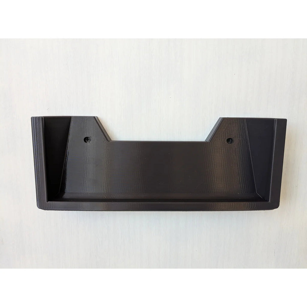 The bare black StarMax bracket mounted to a wall, showing the two countersunk screw holes.