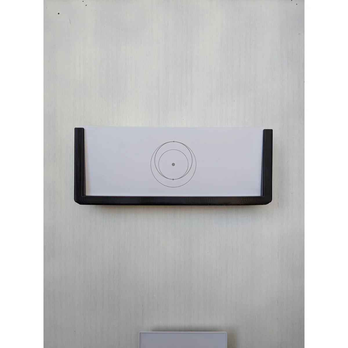 The StarMax bracket installed on a wall with the Starlink Gen 3 router held in place.