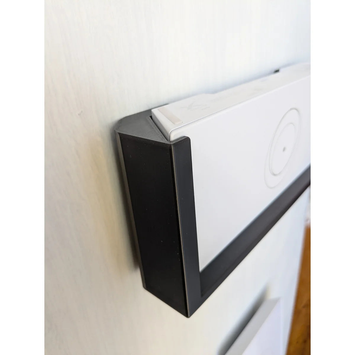 Side perspective of the black StarMax bracket cradling the edge of the Starlink Gen 3 router.