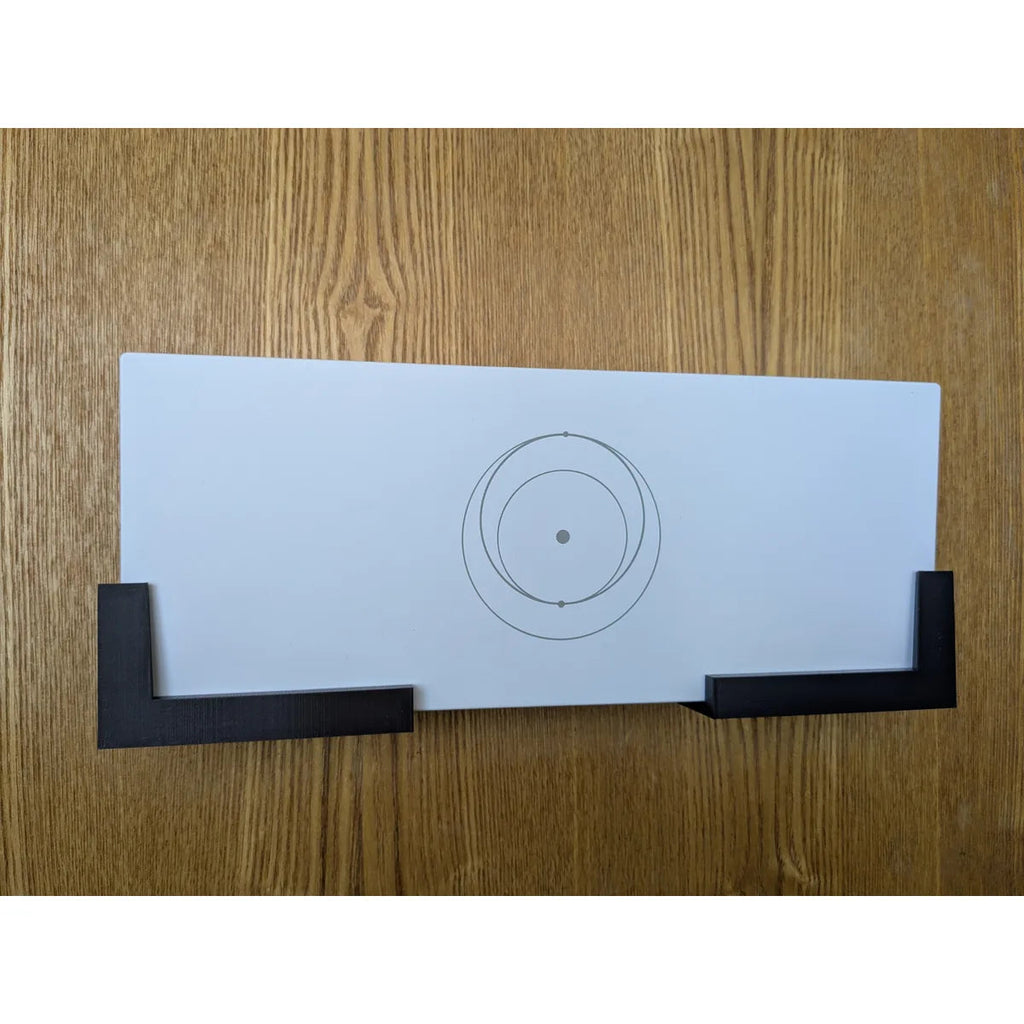 Starlink Gen 3 router beside the two black StarMax wall mount brackets included free with the kit.