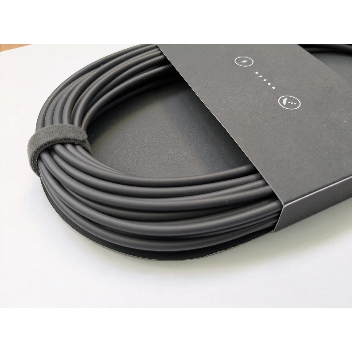 Close-up of the Starlink Mini DC power cable coil showing the smooth outer jacket and securing strap.