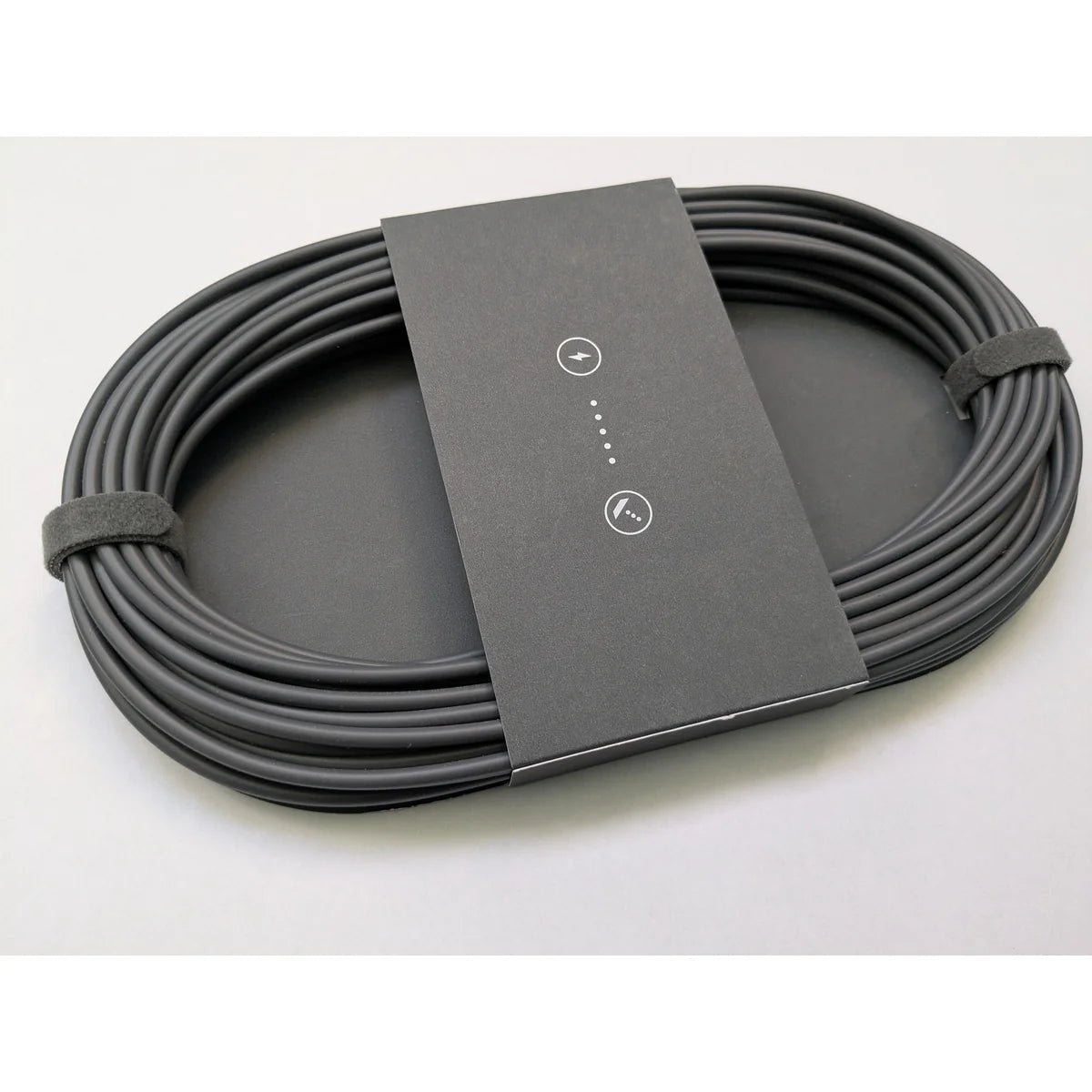 Coiled Starlink Mini DC power cable seen at an angle, showing the printed sleeve and cable thickness.