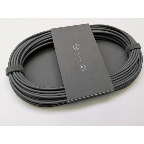 Coiled Starlink Mini DC power cable seen at an angle, showing the printed sleeve and cable thickness.