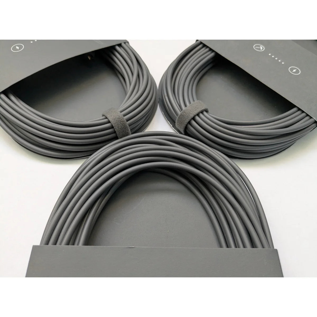 Three coiled Starlink Mini DC power cables arranged together, showing consistent factory coiling.