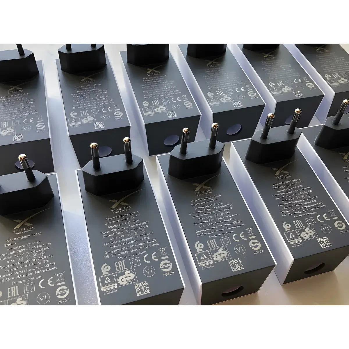 Genuine Starlink Mini power supply units showing embossed specification labels and EU plug pins.