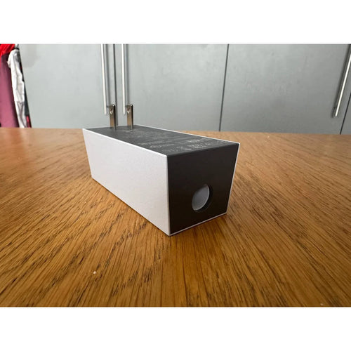 Genuine Starlink Mini power supply, US plug version, angled view showing the DC output port.