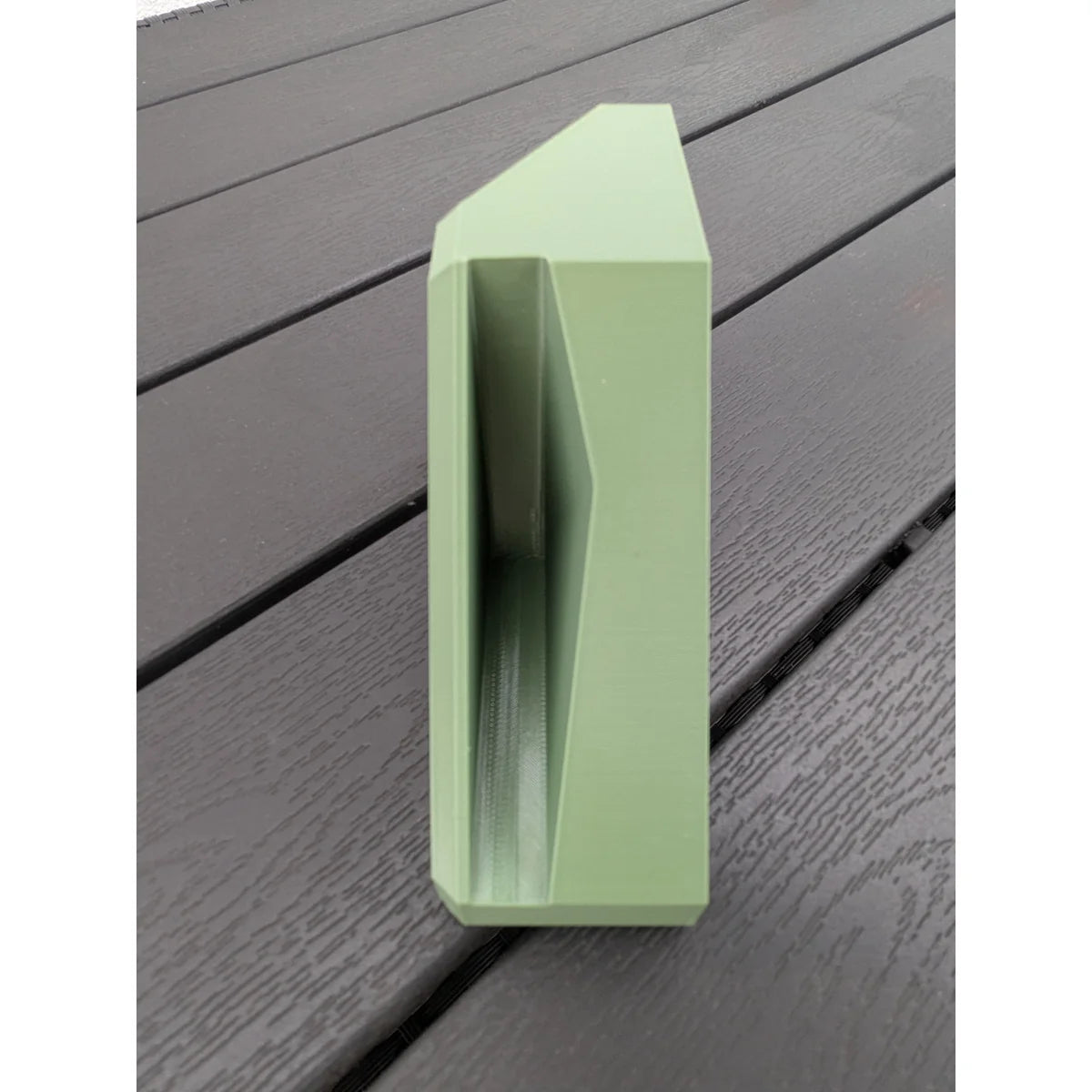 Single StarMax corner bracket stood on edge, showing the internal channel that seats the dish edge.