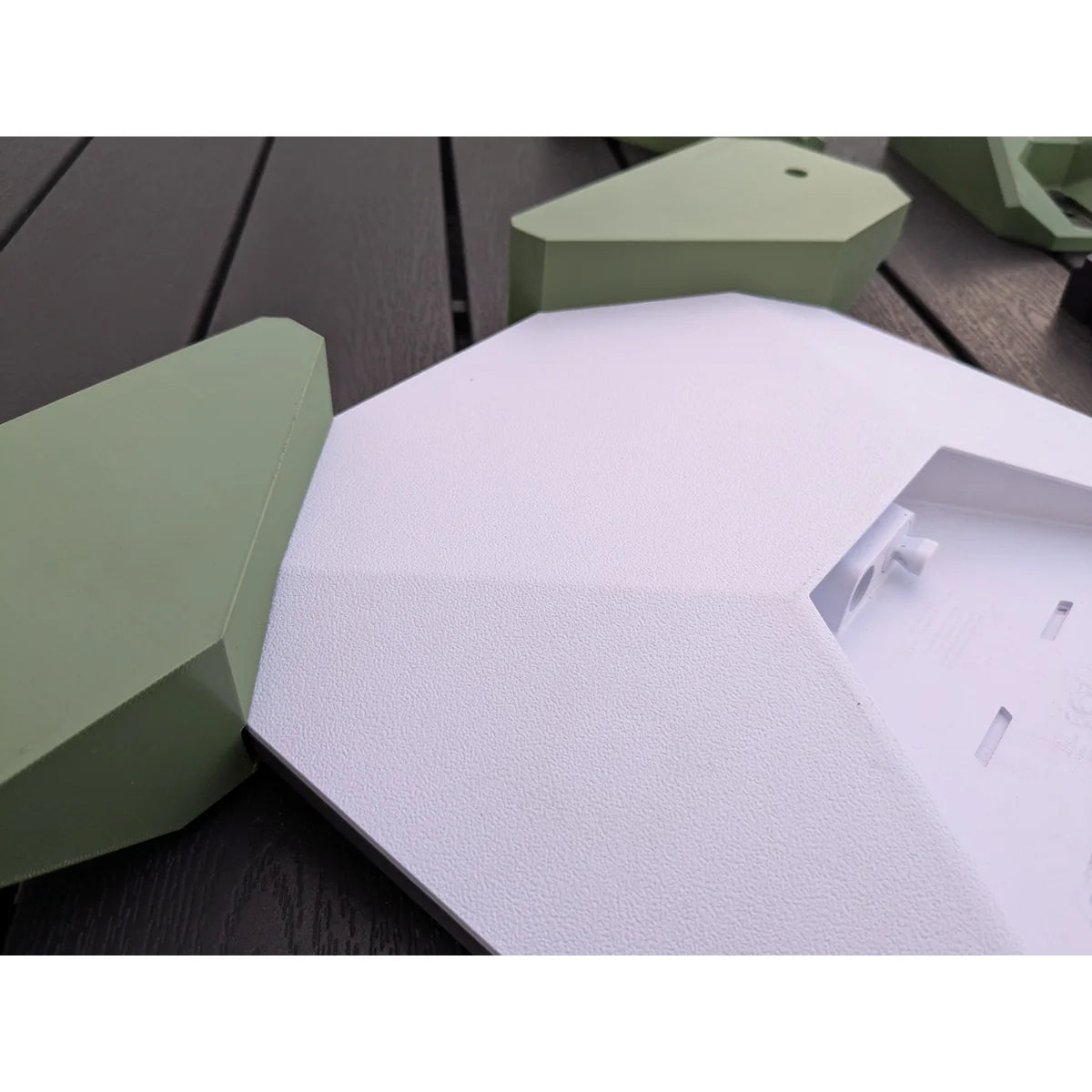 Detail of how the green StarMax bracket meets the Starlink Mini housing, with no gap at the corner.