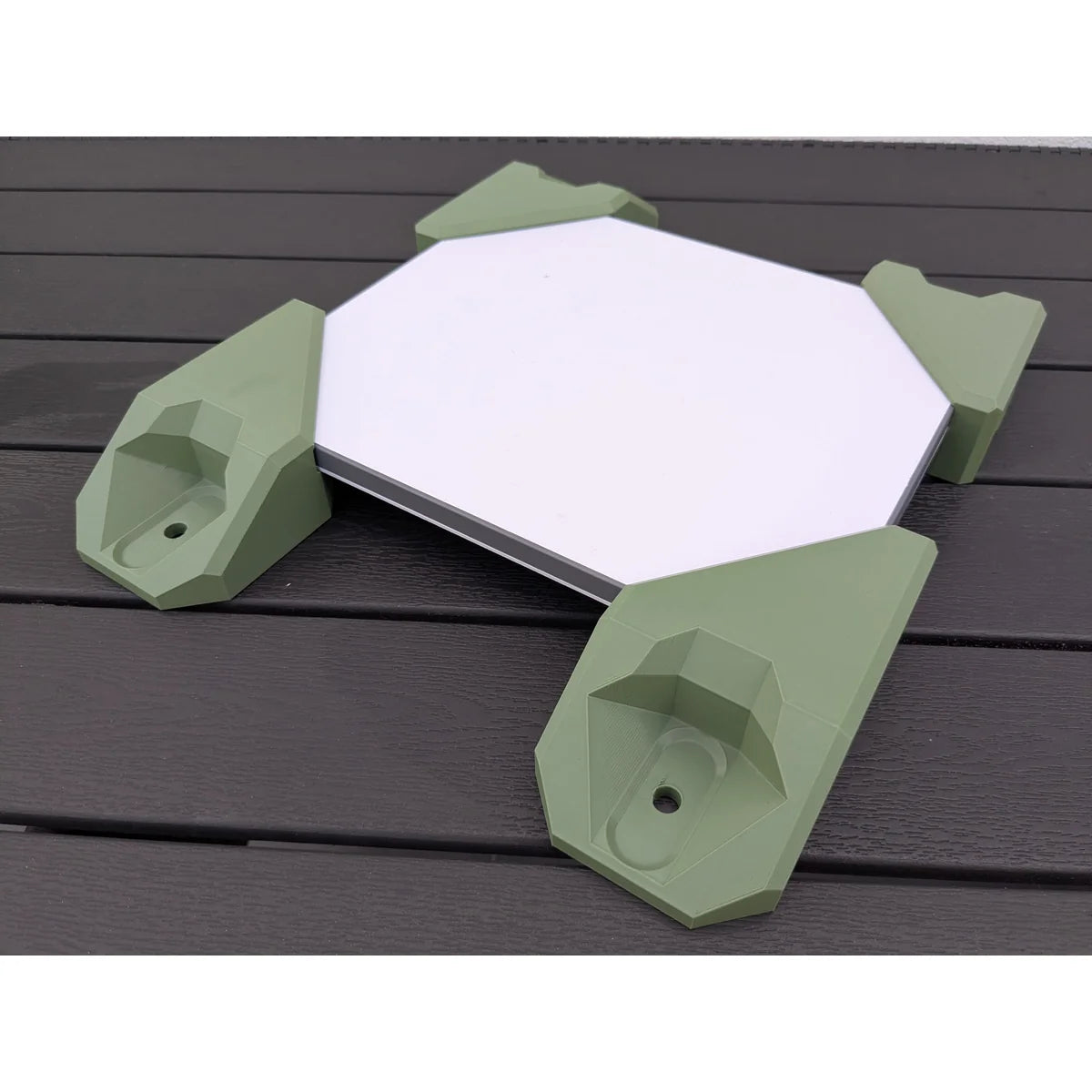 StarMax four-piece corner mount kit in green fitted to a Starlink Mini, seen from above at an angle.