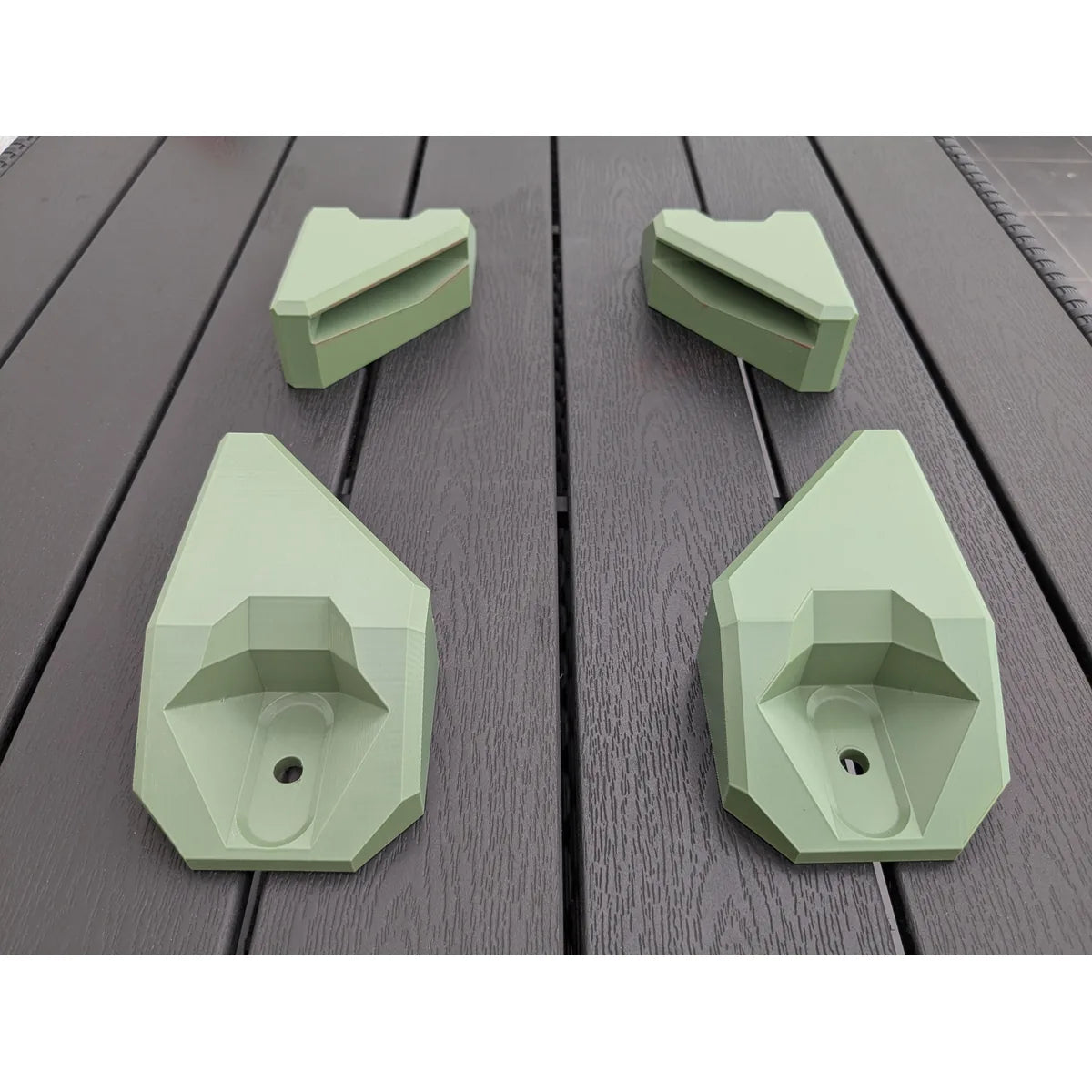 The complete StarMax four-piece corner bracket kit laid out, two front brackets and two rear.