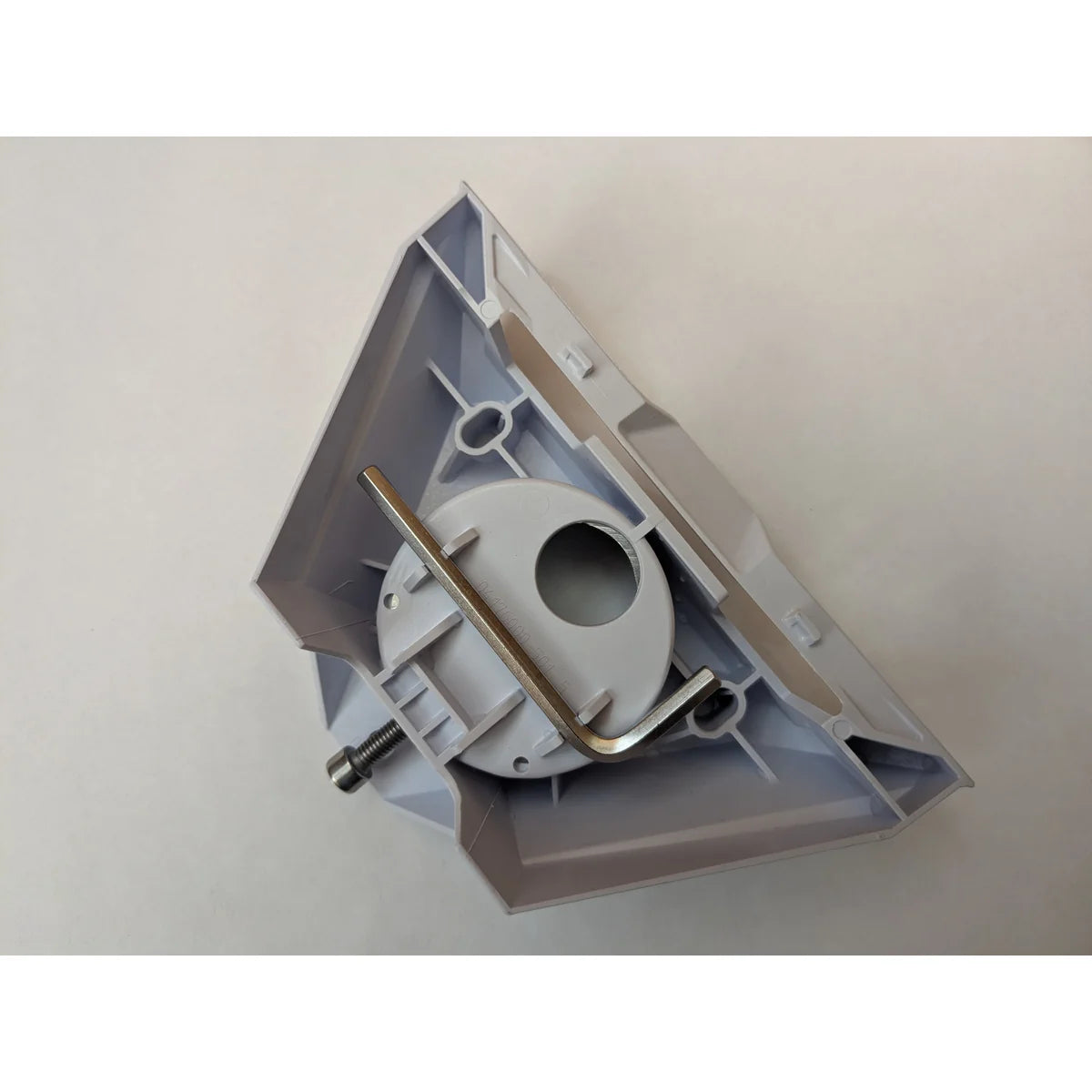 Starlink pipe adapter underside with the supplied hex key resting across the moulded boss.
