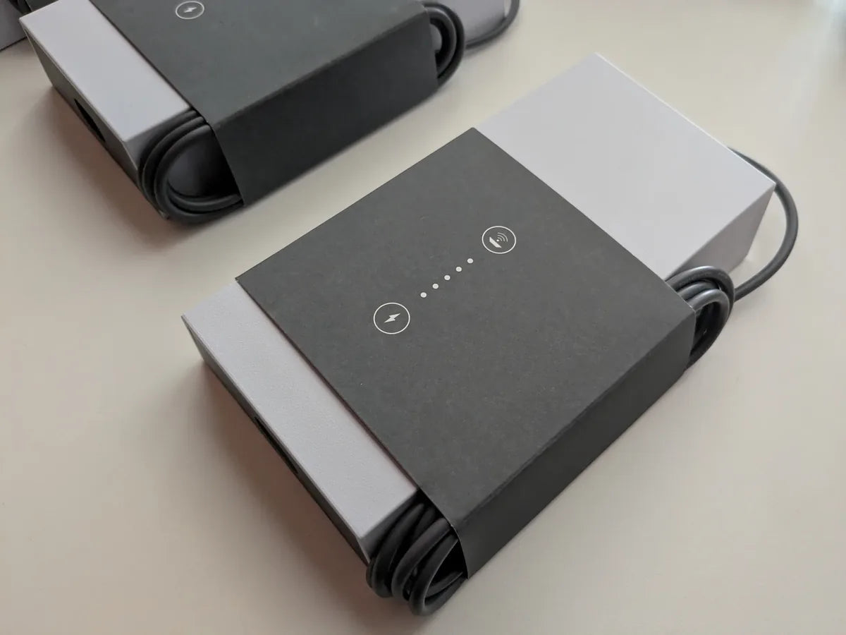 Angled view of a packaged Starlink power supply with its cable wound around the printed sleeve.