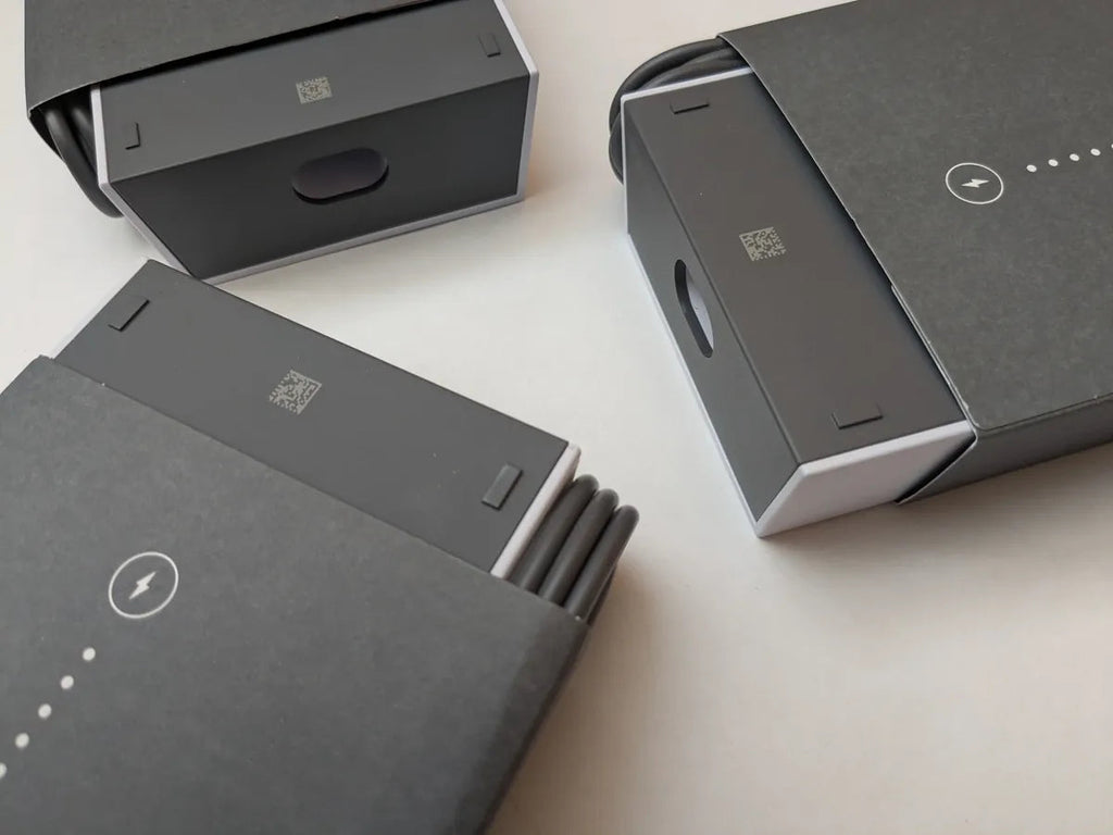 Several packaged Starlink power supplies grouped together, printed sleeves and ports visible.