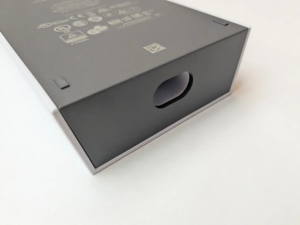 Close detail of the Starlink power supply packaging showing certification marks and the cable port.