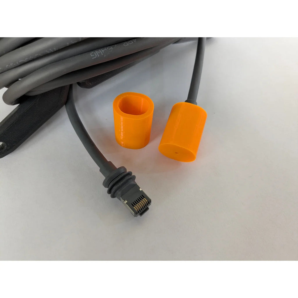 Shielded RJ45 connector of the Starlink cable with its weather gasket, beside the orange cap and collar.