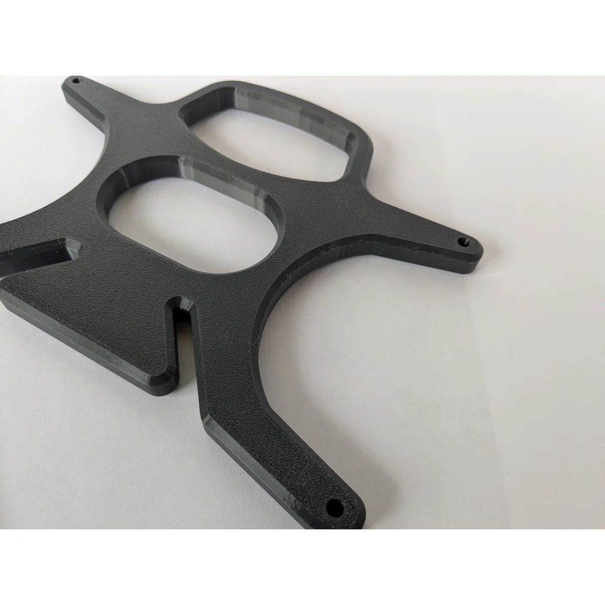 The bare StarMax 3D-printed cable caddy bracket, showing the four-arm frame and printed layer texture.