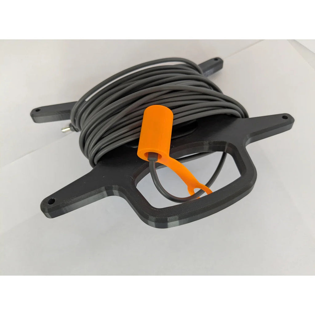 StarMax 3D-printed cable caddy at an angle, holding a wound cable with the orange cap fitted.