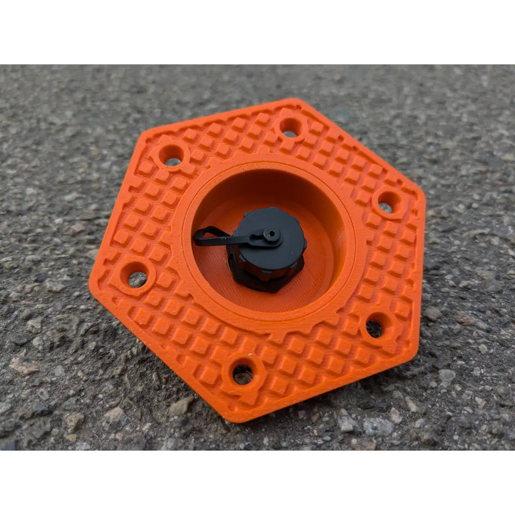 StarMax panel socket in orange with the cap closed, showing the textured hexagonal faceplate.