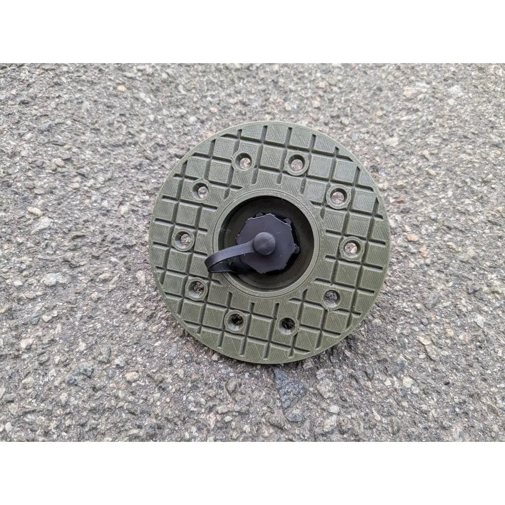 StarMax panel socket on the round olive faceplate, cap closed, showing the twelve fixing holes.