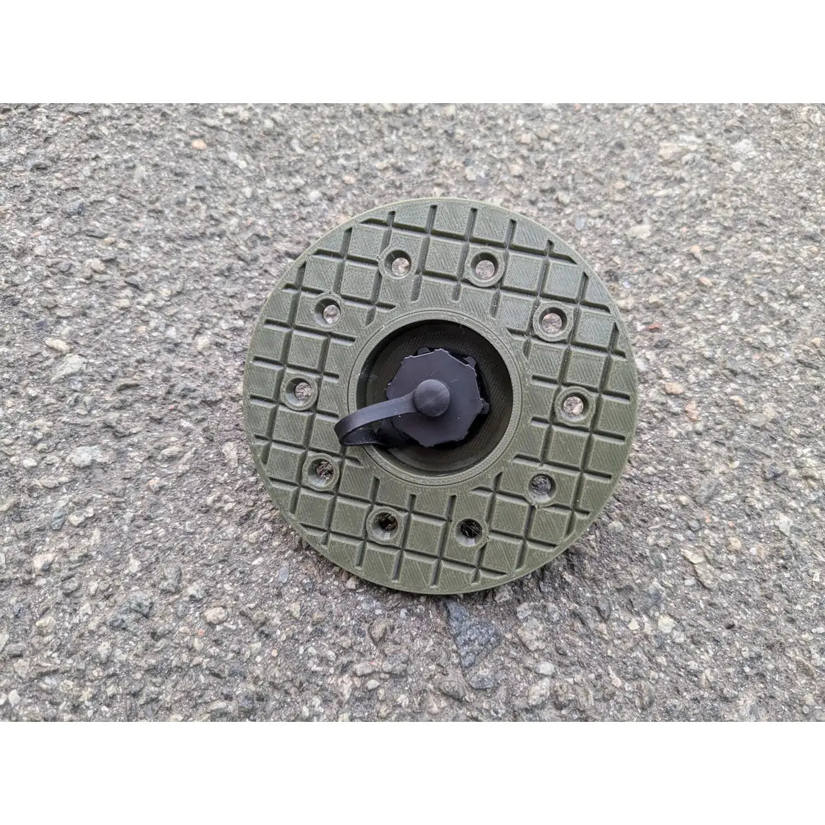 StarMax panel socket on the round olive faceplate, cap closed, showing the twelve fixing holes.