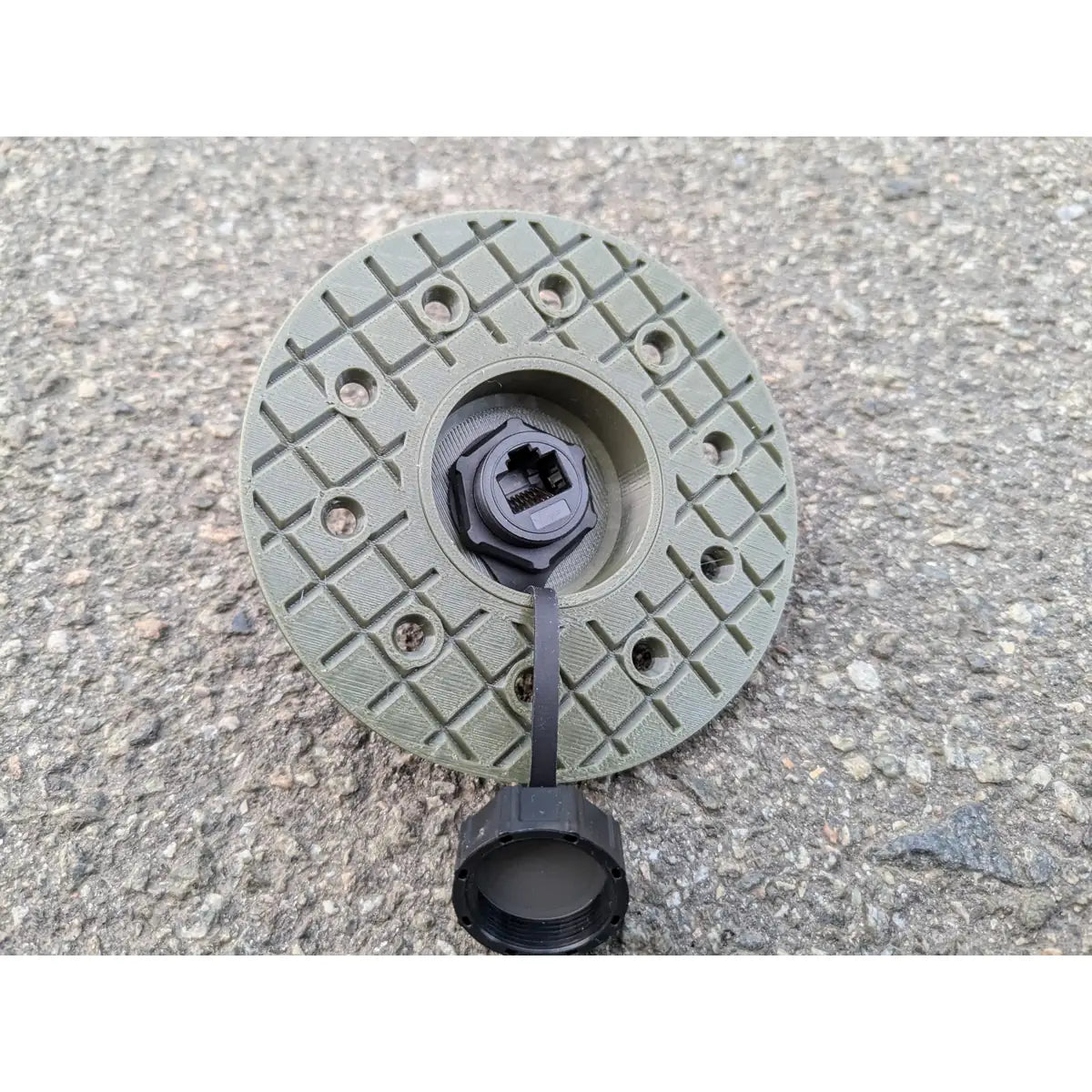 StarMax RJ45 panel socket on the round olive green faceplate with the cap unscrewed.