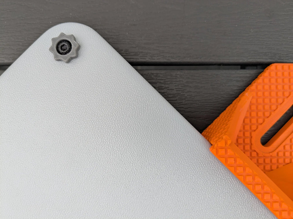 Macro view of an orange StarMax bracket showing the moulded slot and fine surface texture beside the case.
