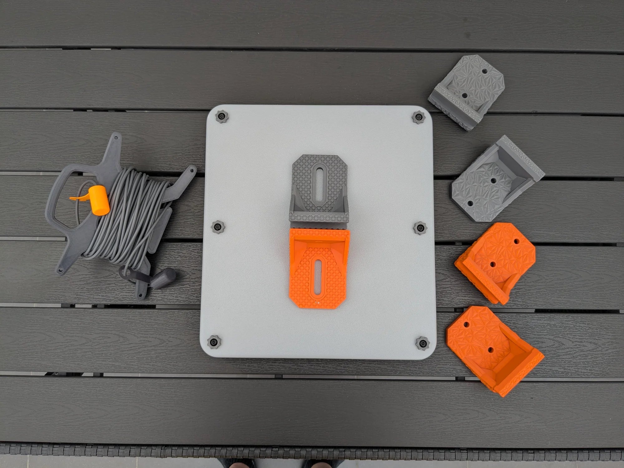 Overhead view of the full StarMax Starlink Mini kit: armor case, four brackets in two colours and cable caddy.