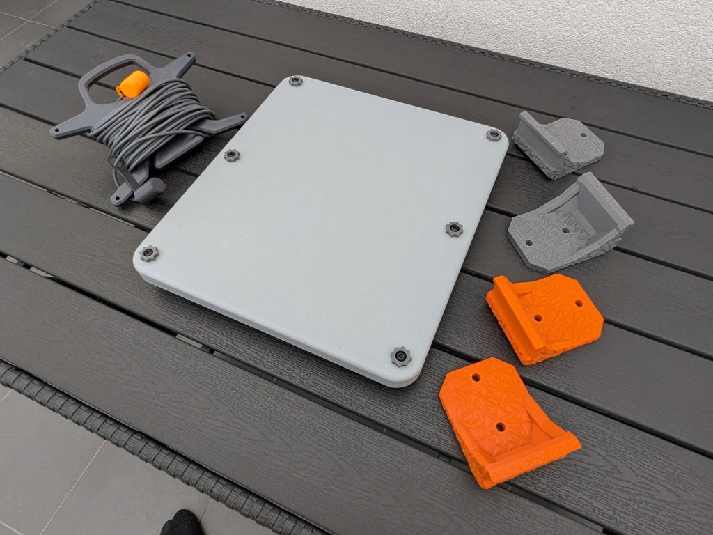 StarMax Starlink Mini kit laid out with cable caddy, armor case and brackets in both grey and orange.