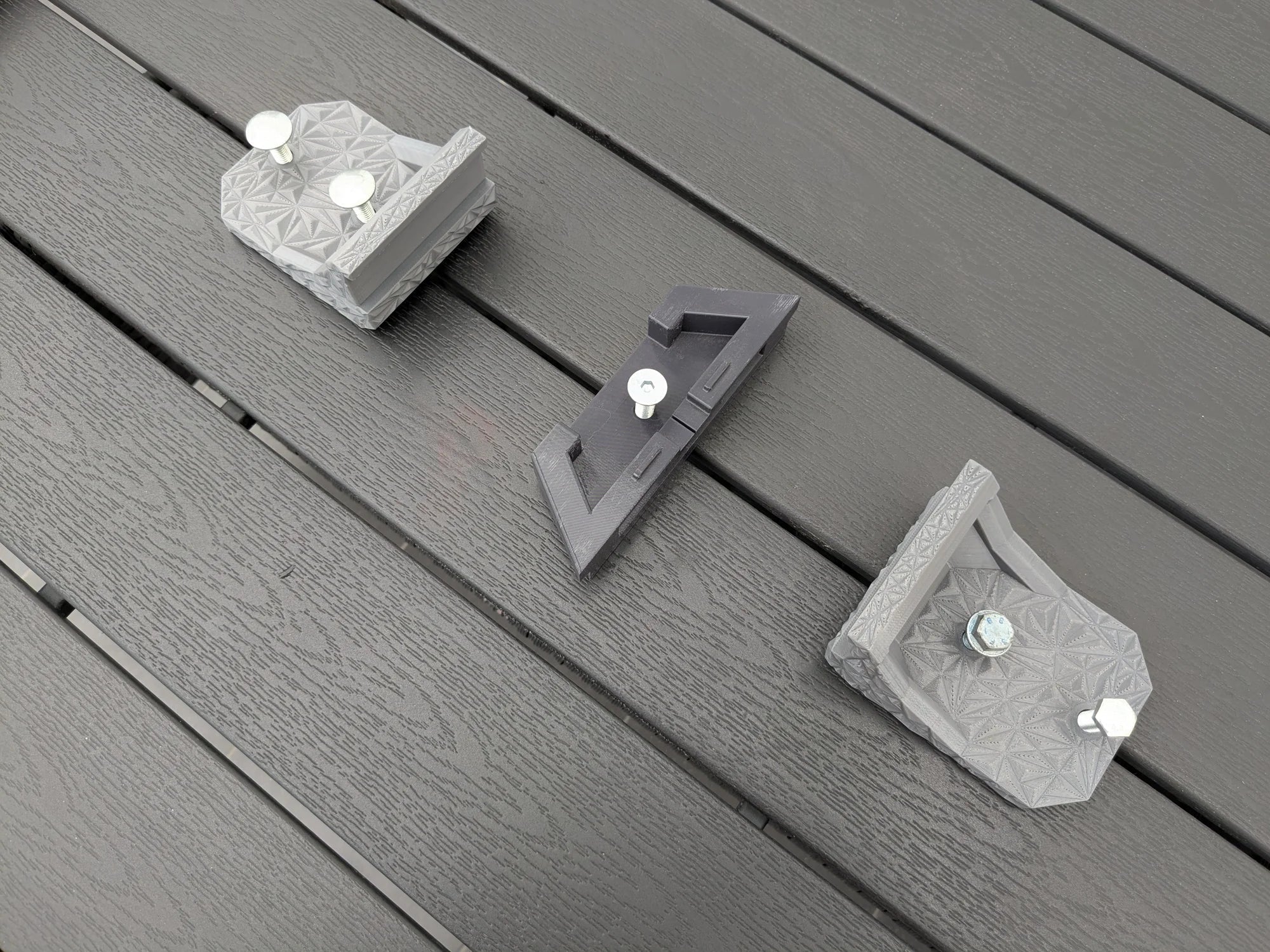 StarMax Starlink Mini mount brackets laid out with zinc-plated bolts inserted through the fixing holes.