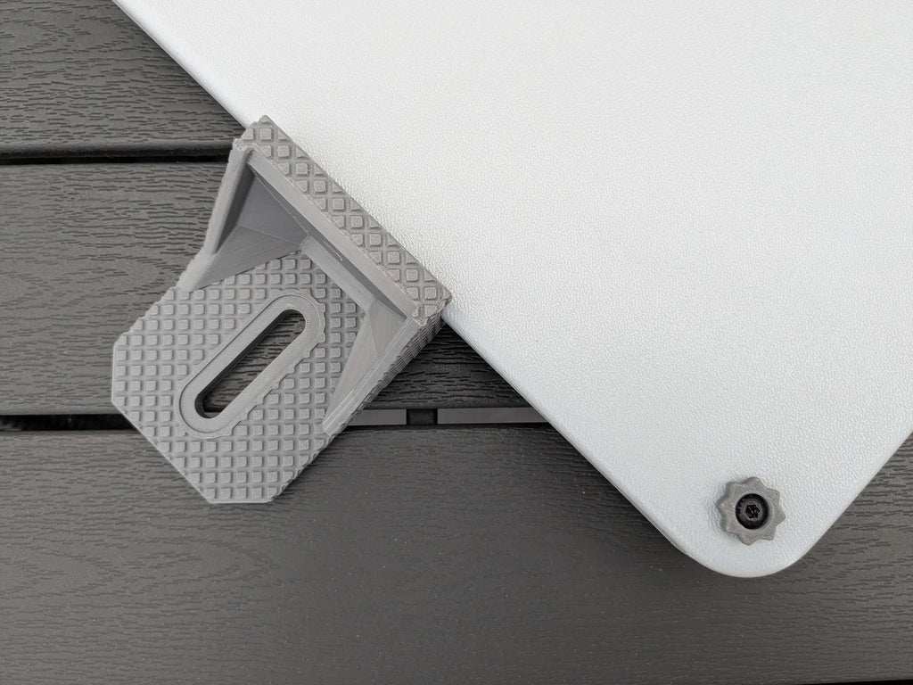 Grey StarMax slotted bracket positioned at the corner of the Starlink Mini armor case, seen from above.